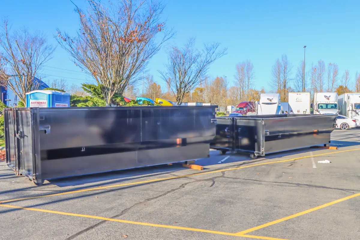 Professional dumpster rental service with roll-off container on residential driveway in Kendall